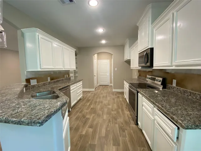a bathroom with a shower and a sink