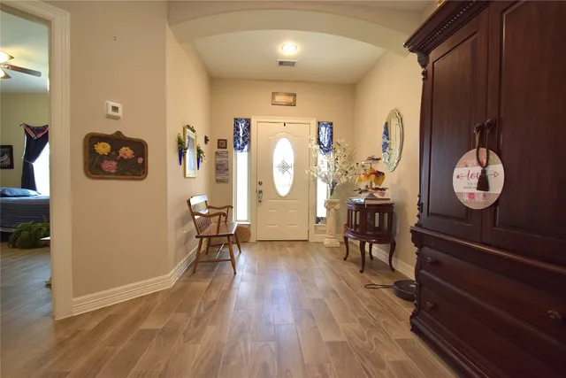 a kitchen with stainless steel appliances kitchen island granite countertop a stove top oven a sink a counter space and cabinets