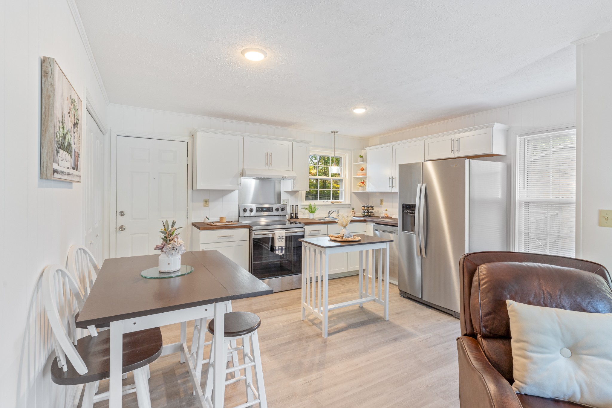 110 Nottingham Road Dickson, TN 37055 - Photo 11 of 34 a kitchen with stainless steel appliances granite countertop a refrigerator a stove a sink a dining table and chairs