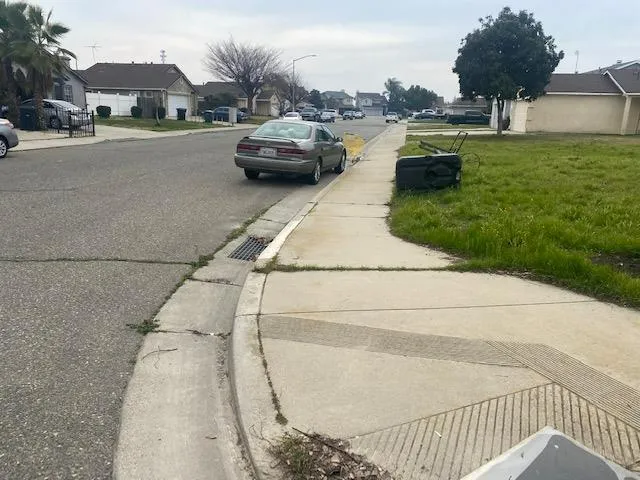 a view of a street with cars parked