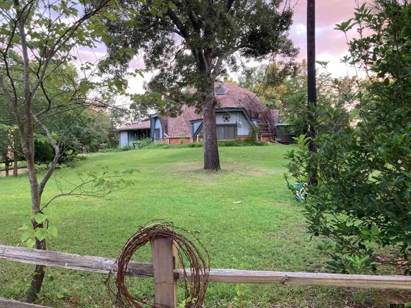 a view of a house with a yard and sitting area
