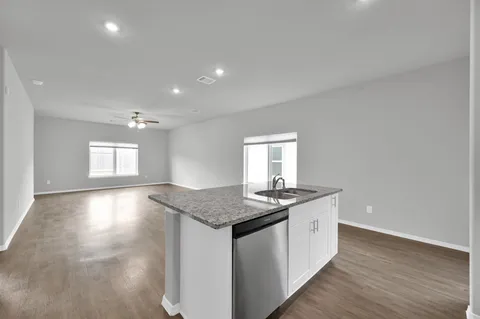 a kitchen with stainless steel appliances granite countertop a sink stove and cabinets