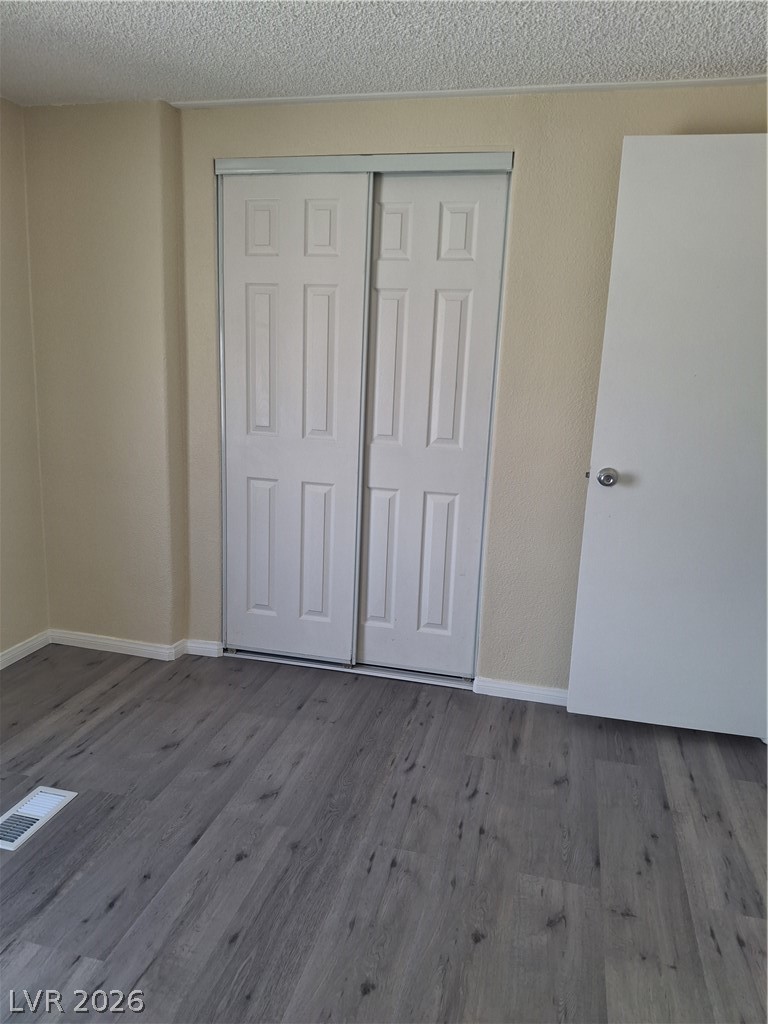 4550 Horn Road Pahrump, NV 89048 - Photo 9 of 12 Streamlined closet doors complement the durable and stylish wood-look flooring.