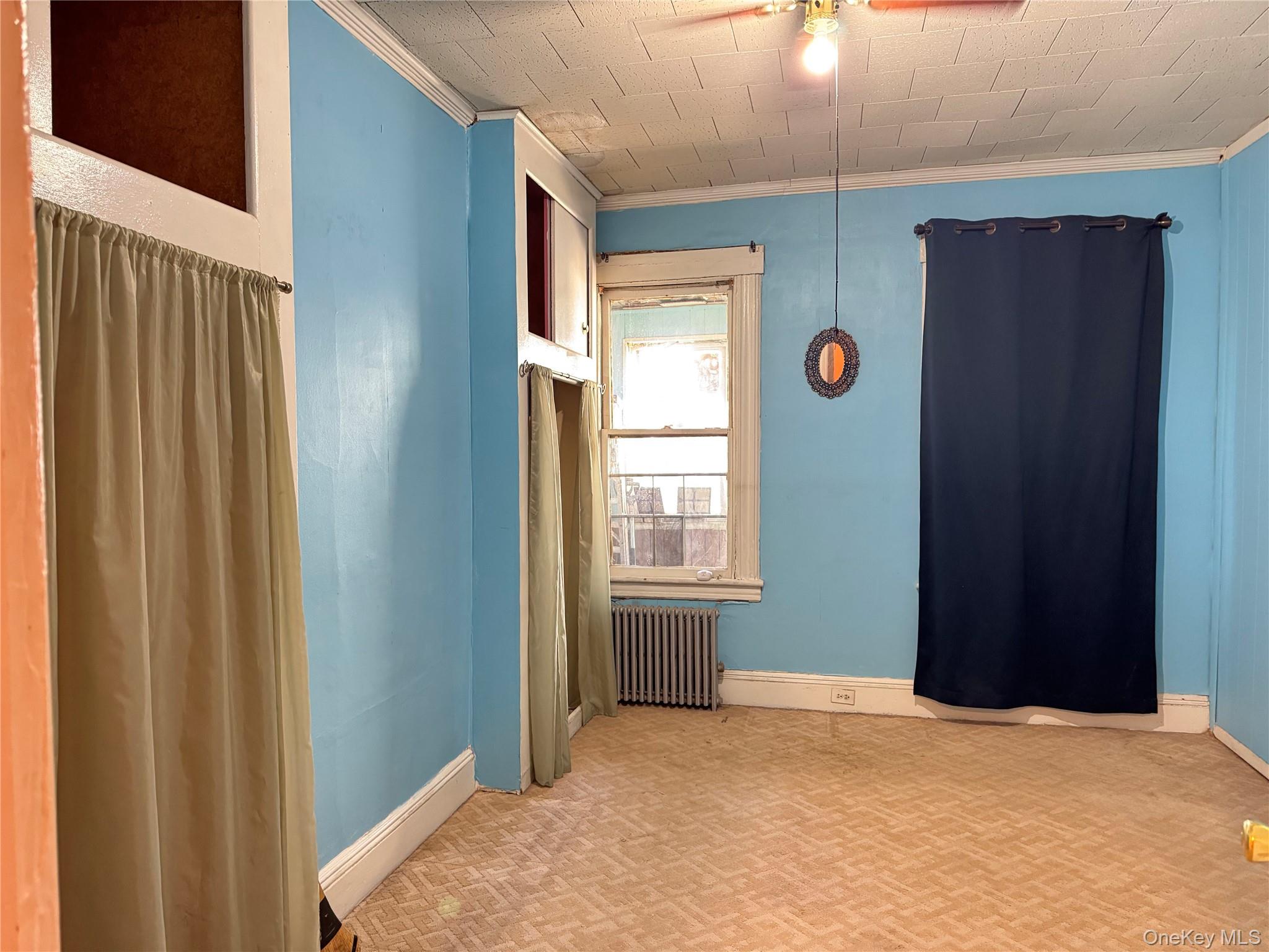 44-11 65th Street Queens, NY 11377 - Photo 11 of 29 a view of an empty room with window and stairs
