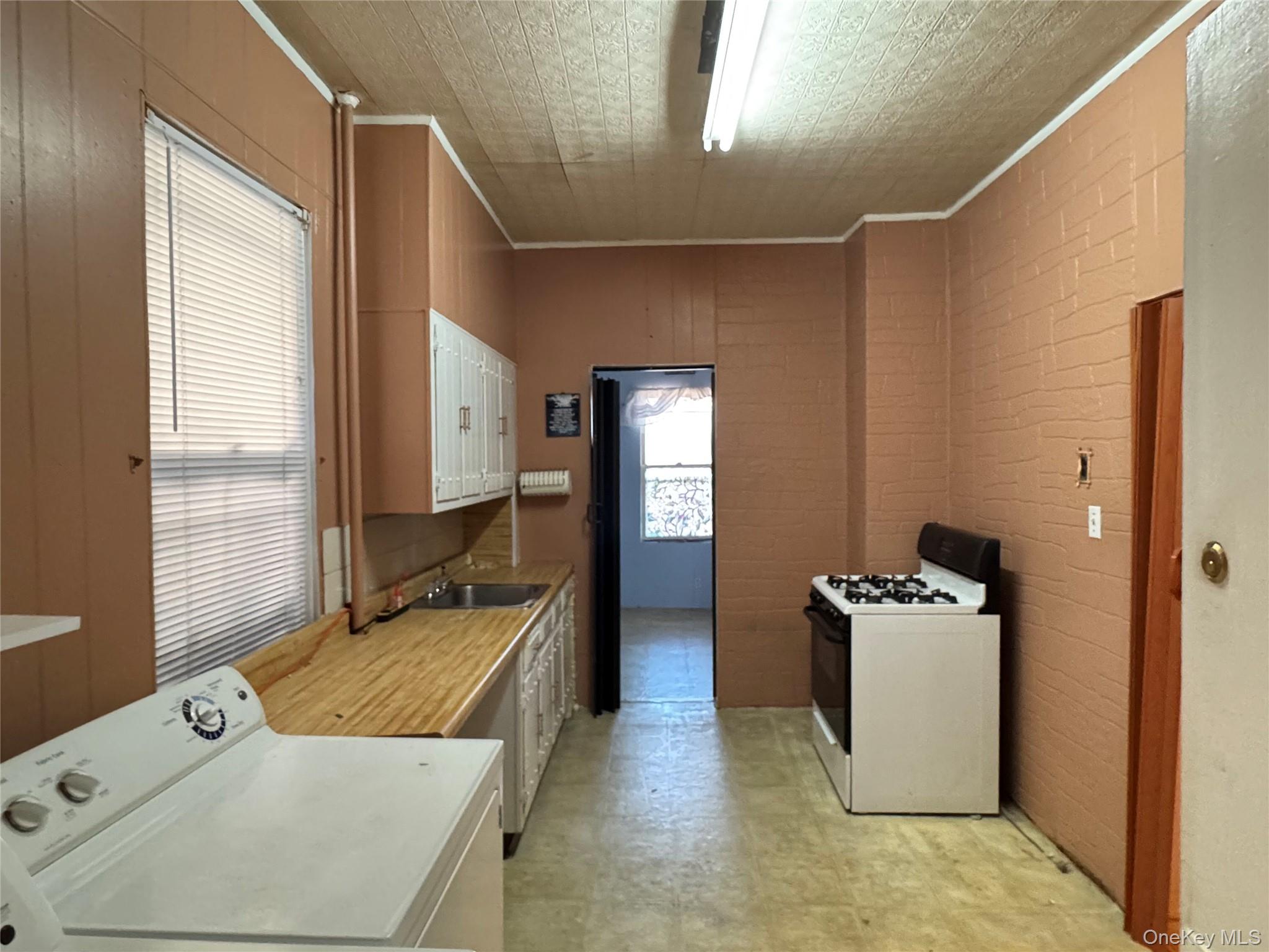 44-11 65th Street Queens, NY 11377 - Photo 16 of 29 a kitchen with a stove and a refrigerator