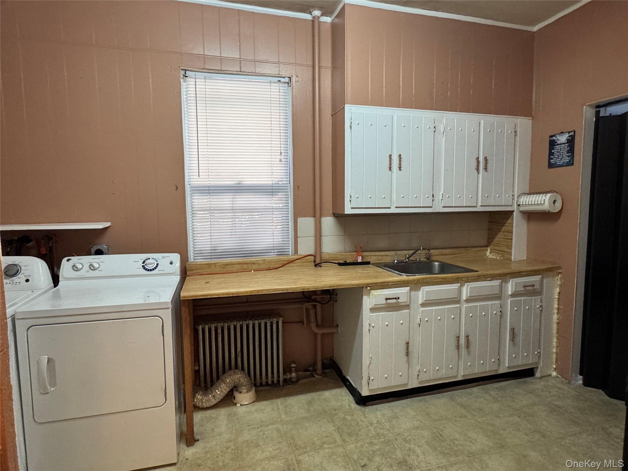 44-11 65th Street Queens, NY 11377 - Photo 17 of 29 a utility room with dryer and washer