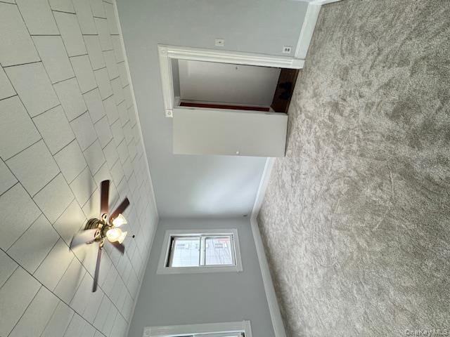 44-11 65th Street Queens, NY 11377 - Photo 21 of 29 an empty room with windows and fan