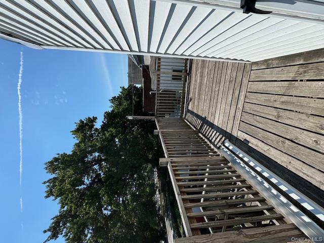 44-11 65th Street Queens, NY 11377 - Photo 3 of 29 a balcony with wooden floor and city view