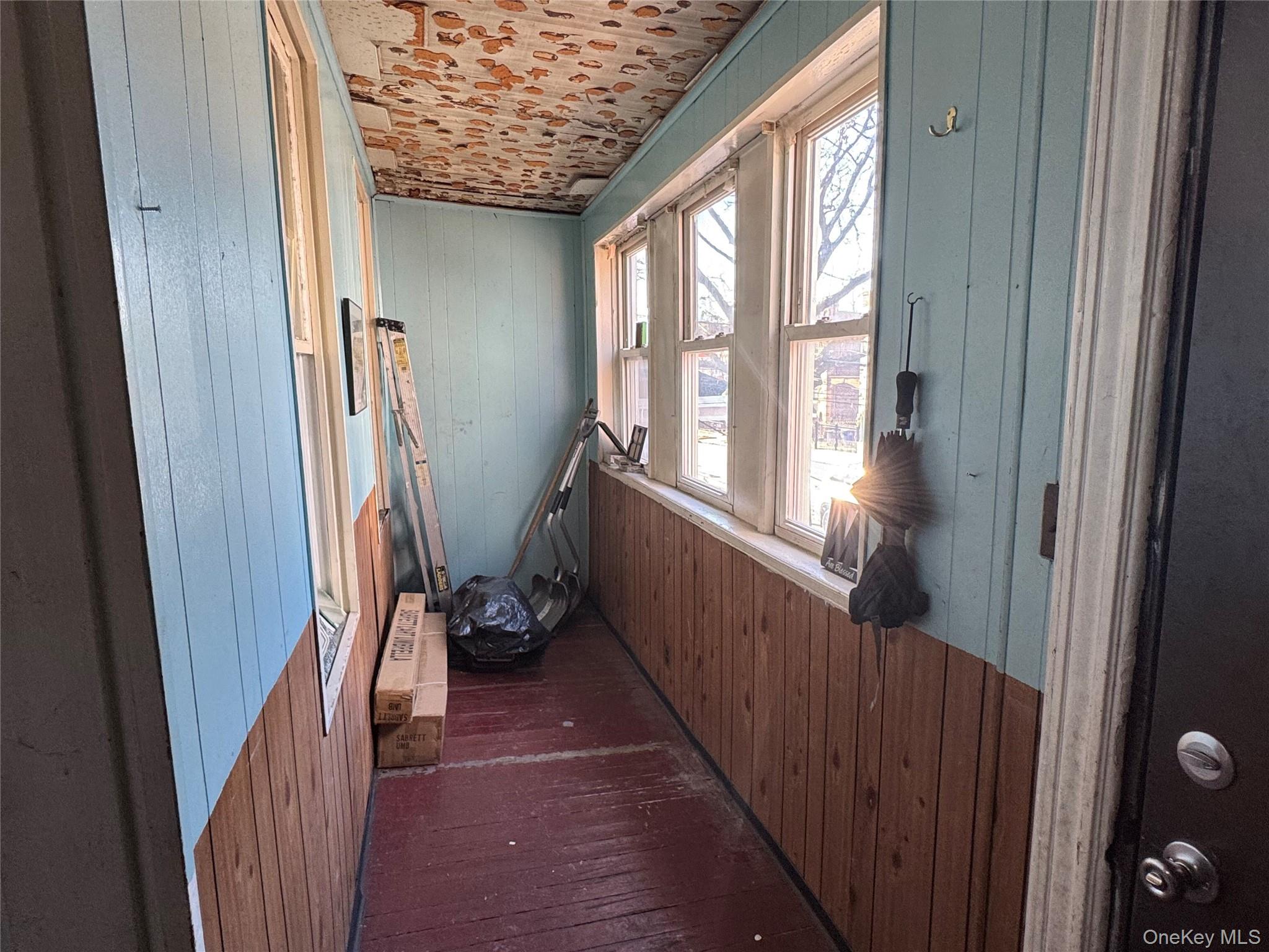 44-11 65th Street Queens, NY 11377 - Photo 10 of 29 a view of a hallway with wooden floor and stairs
