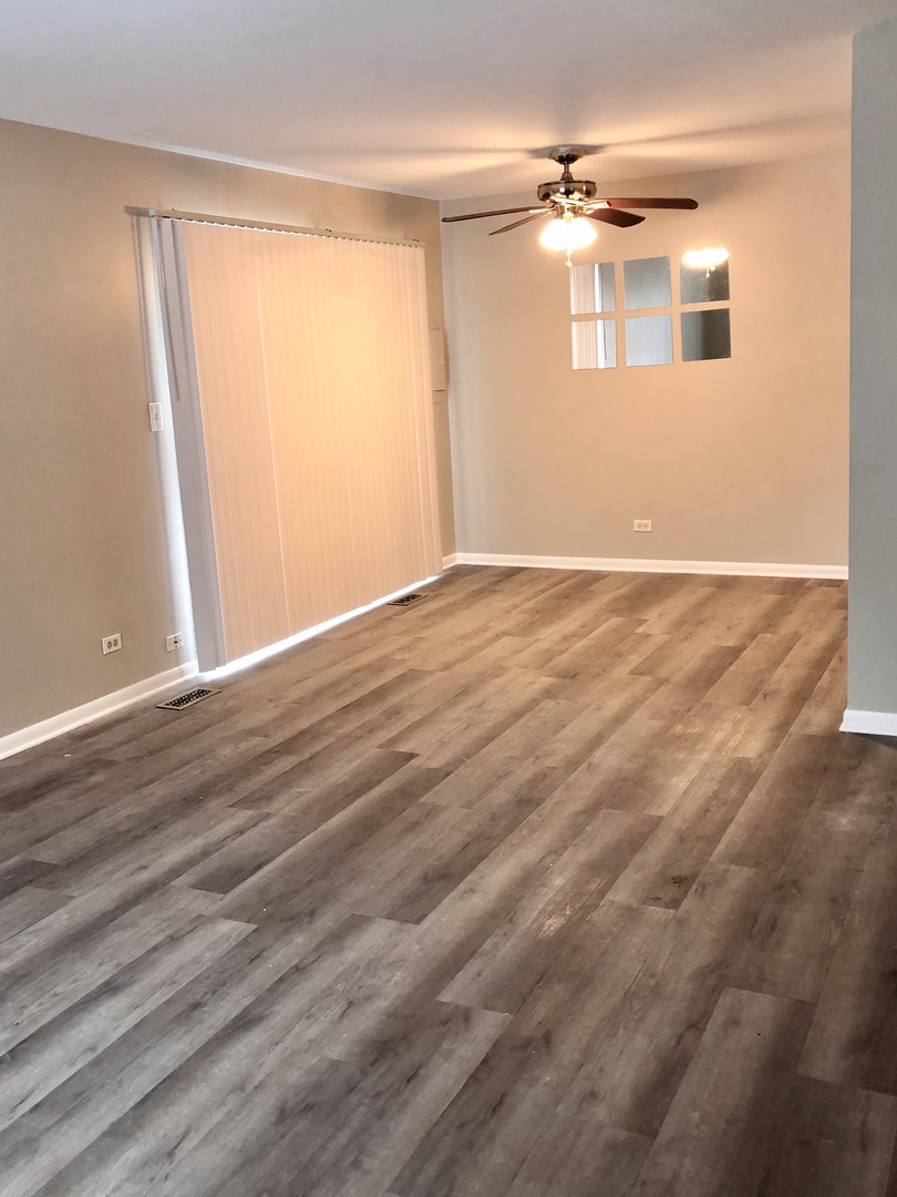 1769 Raleigh Lane Hoffman Estates, IL 60169 - Photo 15 of 17 a view of an empty room with wooden floor and a window