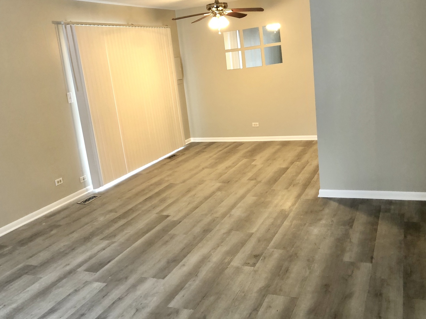 1769 Raleigh Lane Hoffman Estates, IL 60169 - Photo 5 of 17 an empty room with wooden floor and windows
