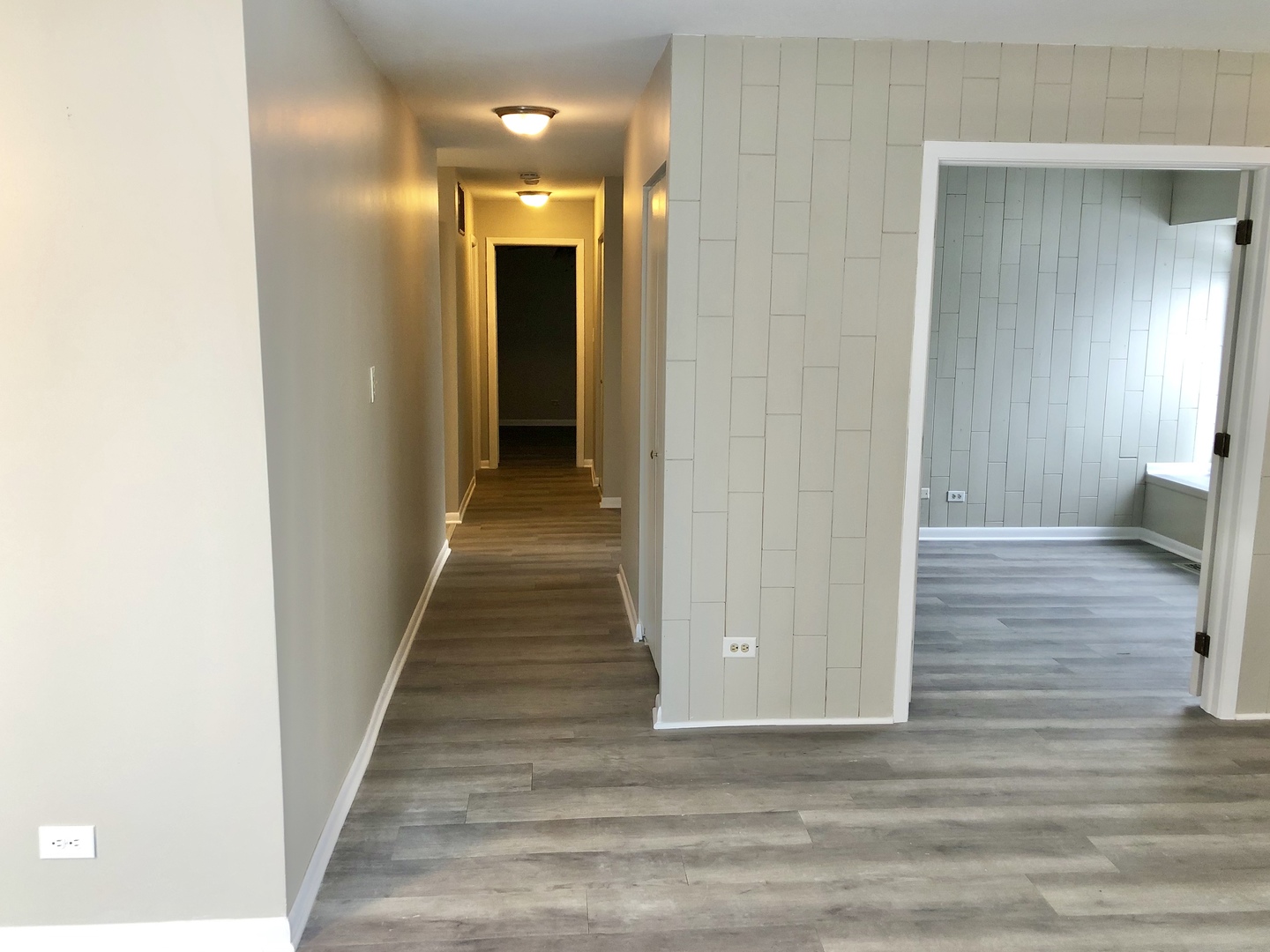 1769 Raleigh Lane Hoffman Estates, IL 60169 - Photo 7 of 17 a view of a hallway with wooden floor and staircase