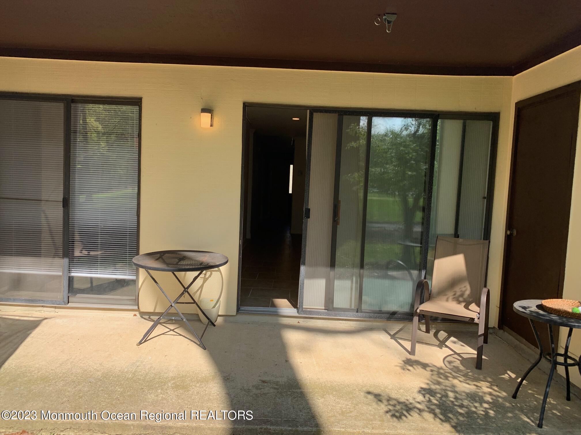 90 Arrowood Road, Unit D Manalapan, NJ 07726 - Photo 11 of 13 a room with table and chairs