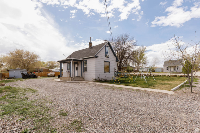 197 West 100 South Redmond, UT 84652 - Photo 2 of 41 Bungalow-style home featuring a chimney, a front lawn, and a playground