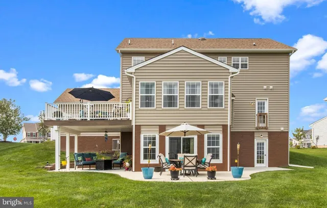 a view of a patio with furniture and a yard
