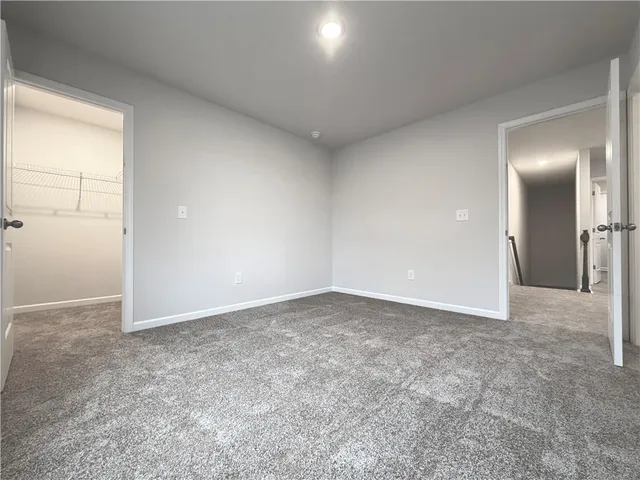 an empty room with window in bathroom