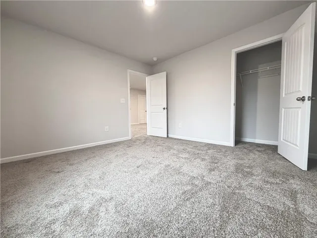 a view of an empty room and closet area