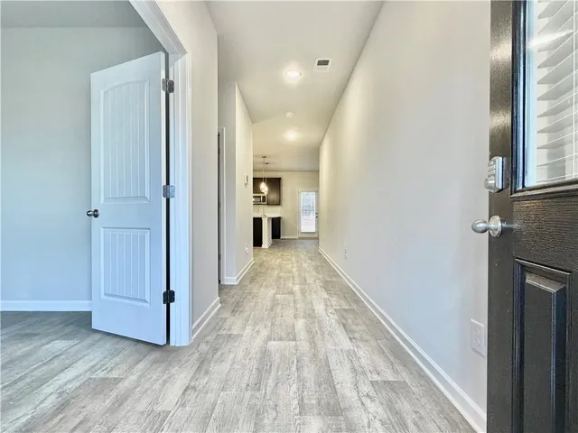a view of hallway with wooden floor