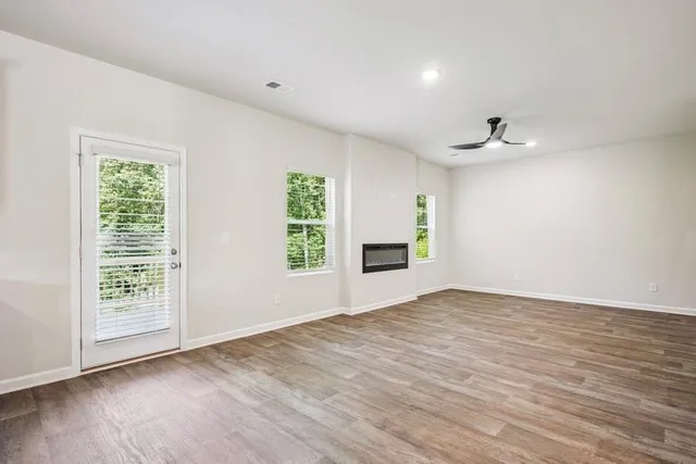 wooden floor in an empty room with a window