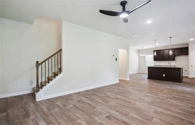 a view of kitchen with microwave and wooden floor