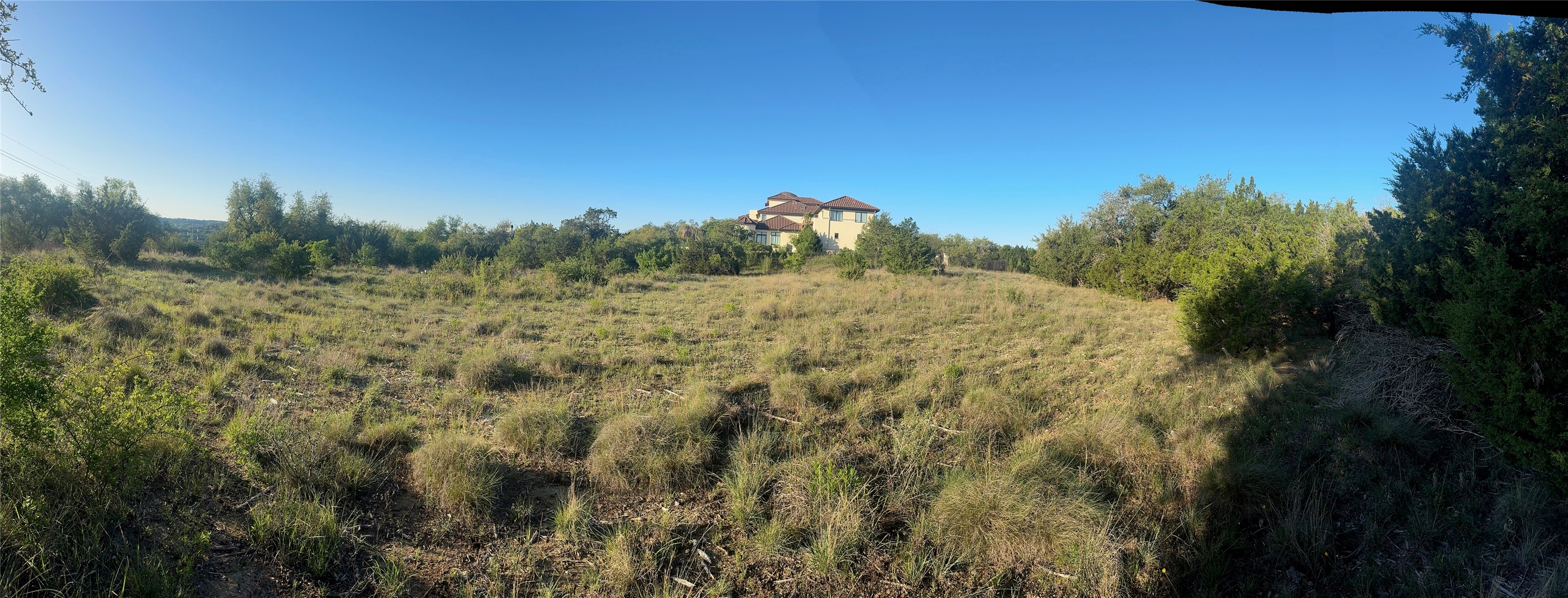608 Marly Way, Unit 5 Austin, TX 78733 - Photo 18 of 30 Panoramic view of the lot back on left, front on right. The waviness is artefact. Lot is flat.