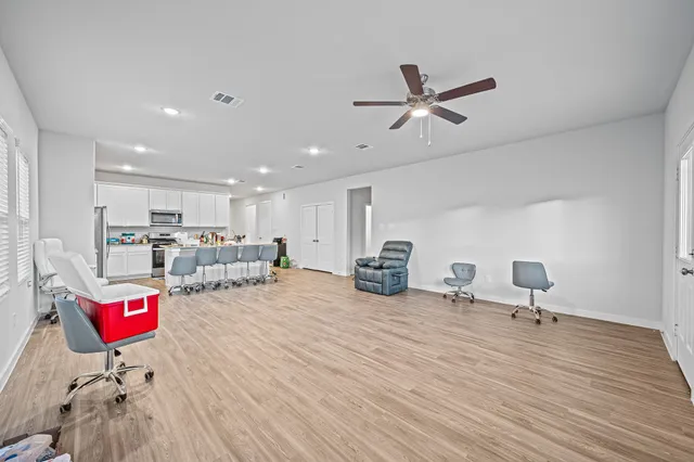 a living room with furniture and kitchen view
