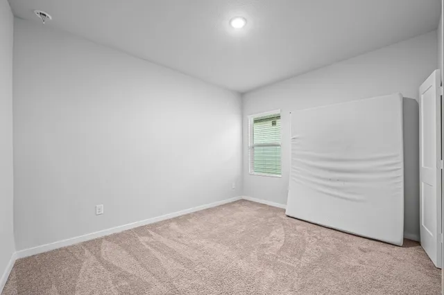 a view of an empty room and a window