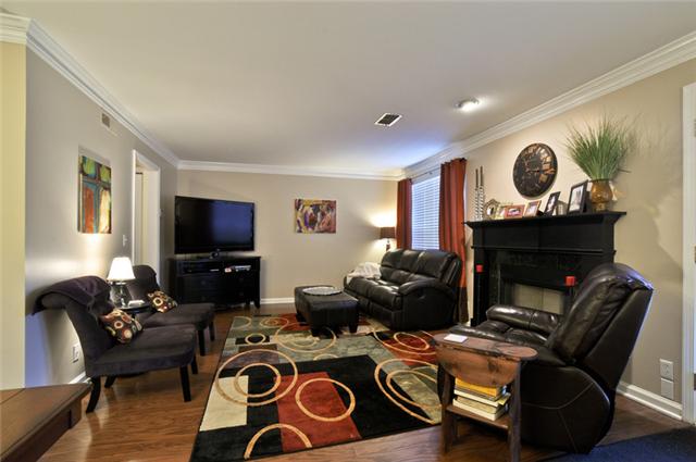 Living Room with wood burning fireplace and new wood floors 