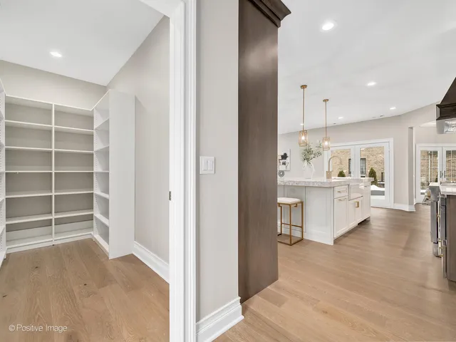 a view of kitchen with kitchen island white cabinets and refrigerator