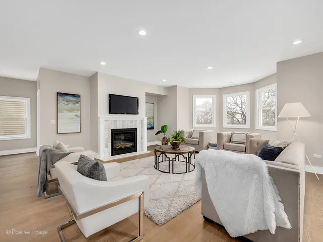 a living room with furniture fireplace and window