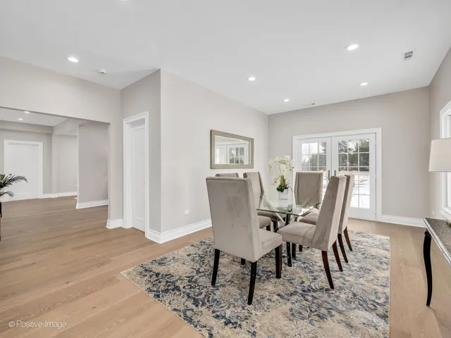 a dining room with furniture and wooden floor