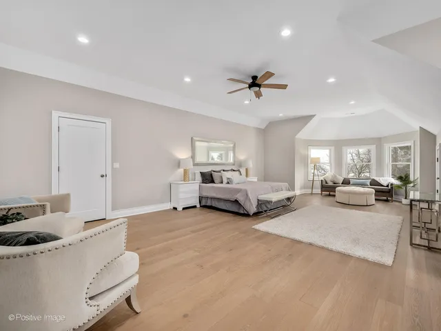 a living room with furniture and a ceiling fan