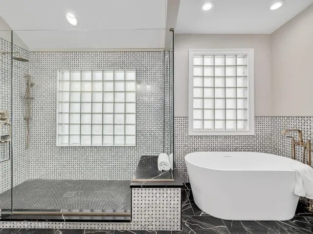 a bathroom with a bathtub and window
