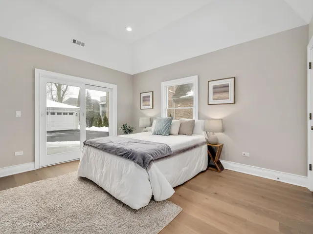 a spacious bedroom with a bed and a large window