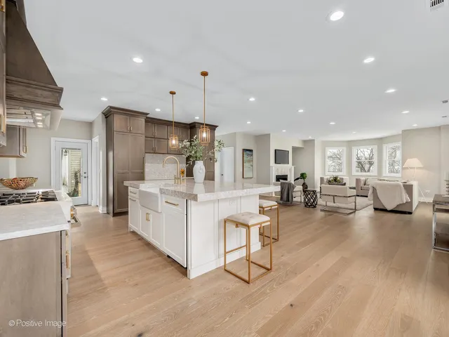 a large white kitchen with lots of counter space and furniture