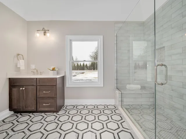a bathroom with a sink vanity granite and a mirror
