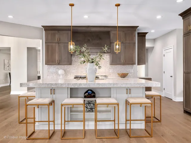 a kitchen with a table chairs refrigerator and microwave