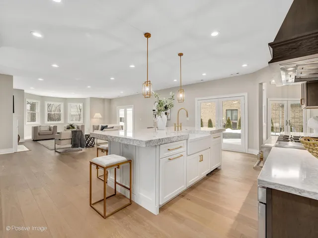 a large kitchen with lots of counter space dining table and chairs