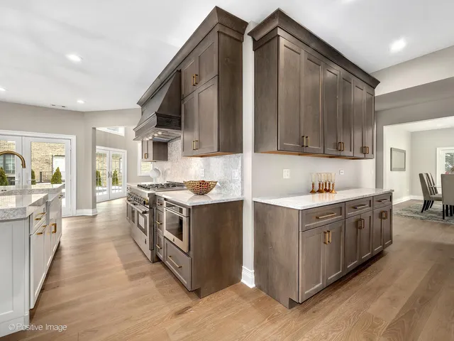 a kitchen with stainless steel appliances granite countertop a stove and a sink