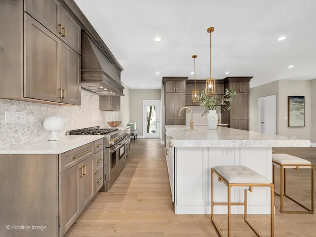 a kitchen with kitchen island granite countertop lots of counter top space and sink