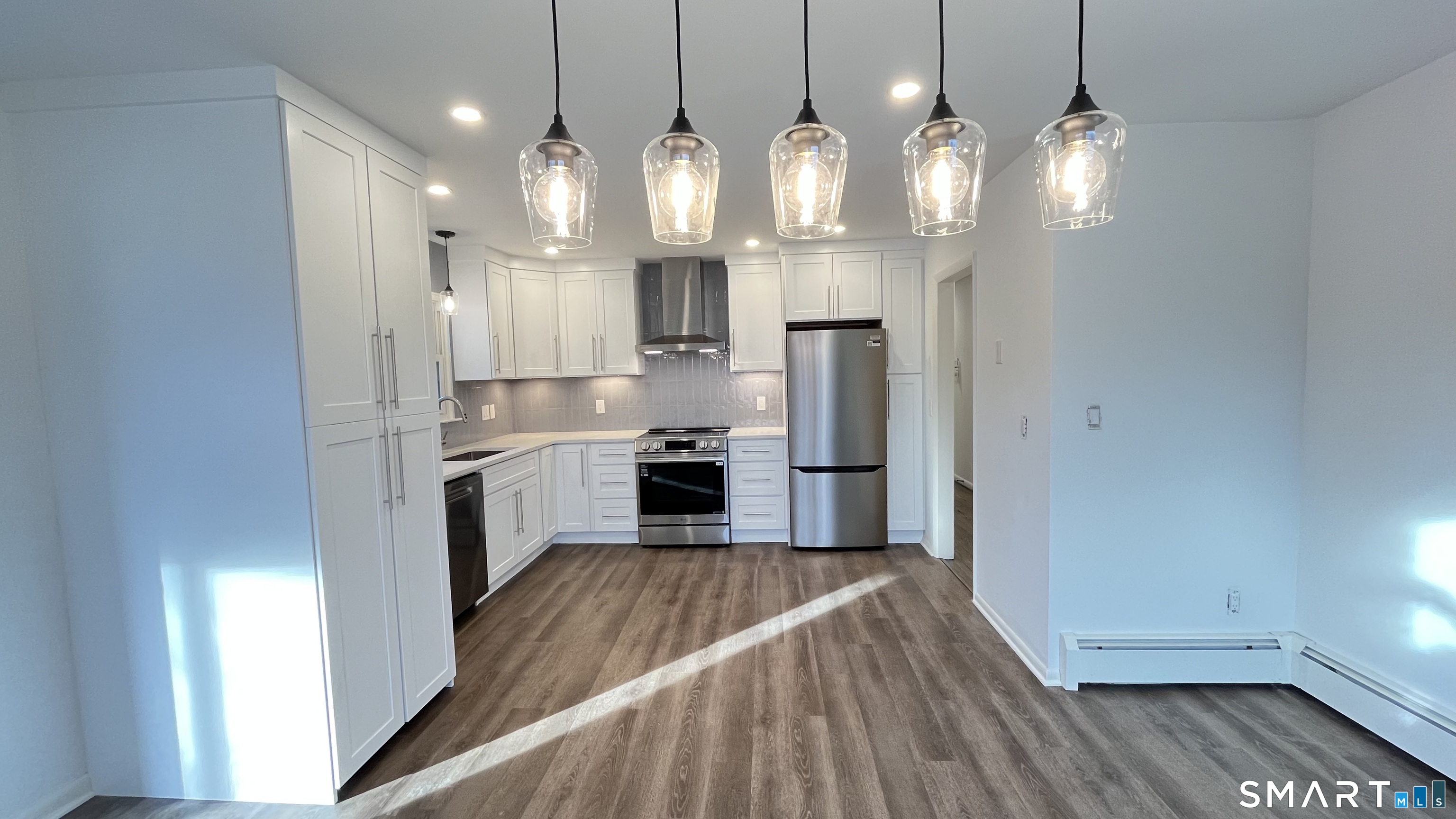 34 Keith Street, Unit 2 Stamford, CT 06902 - Photo 4 of 15 a kitchen with stainless steel appliances a refrigerator sink and microwave