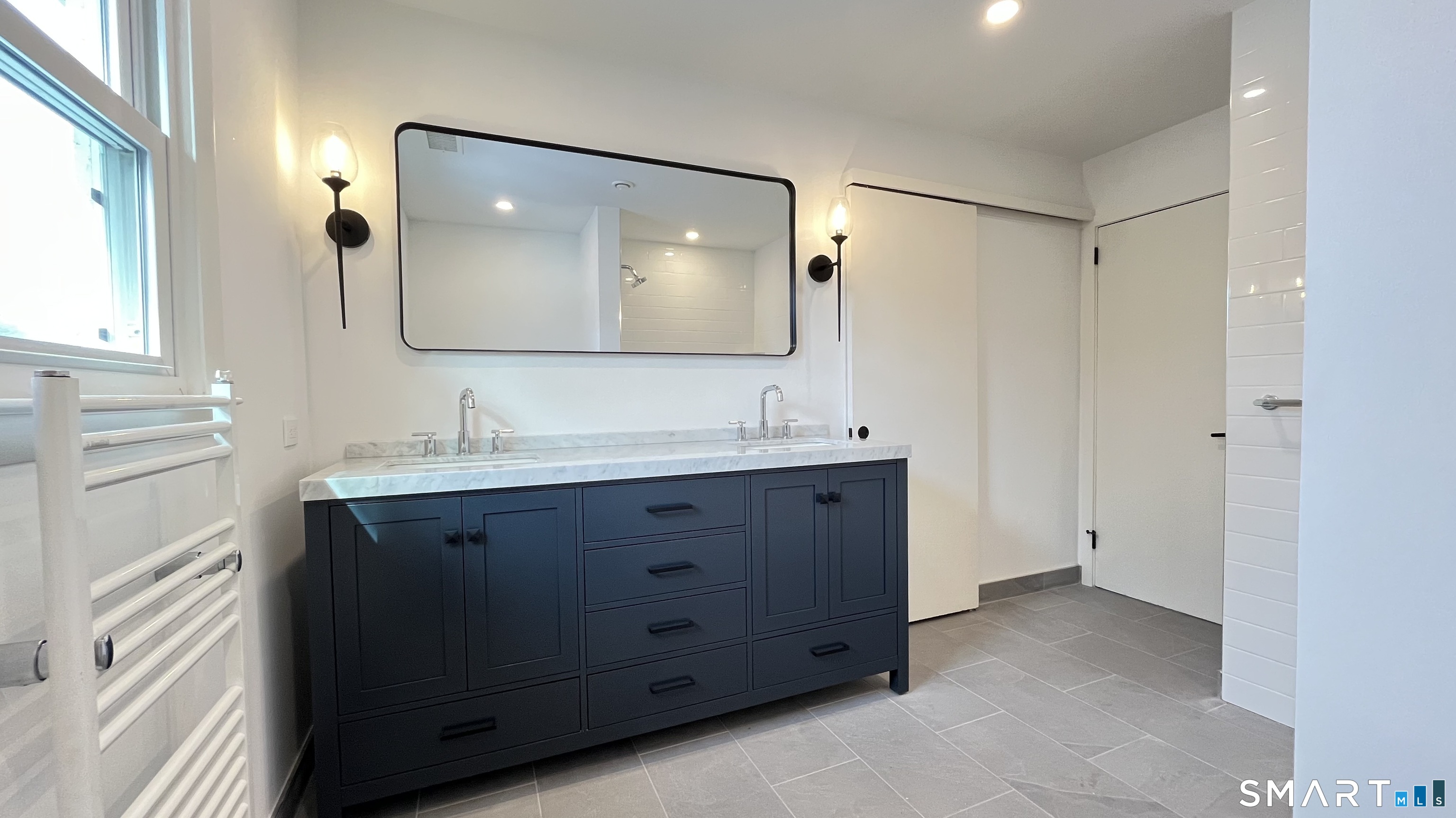 34 Keith Street, Unit 2 Stamford, CT 06902 - Photo 8 of 15 a bathroom with a double vanity sink mirror and double