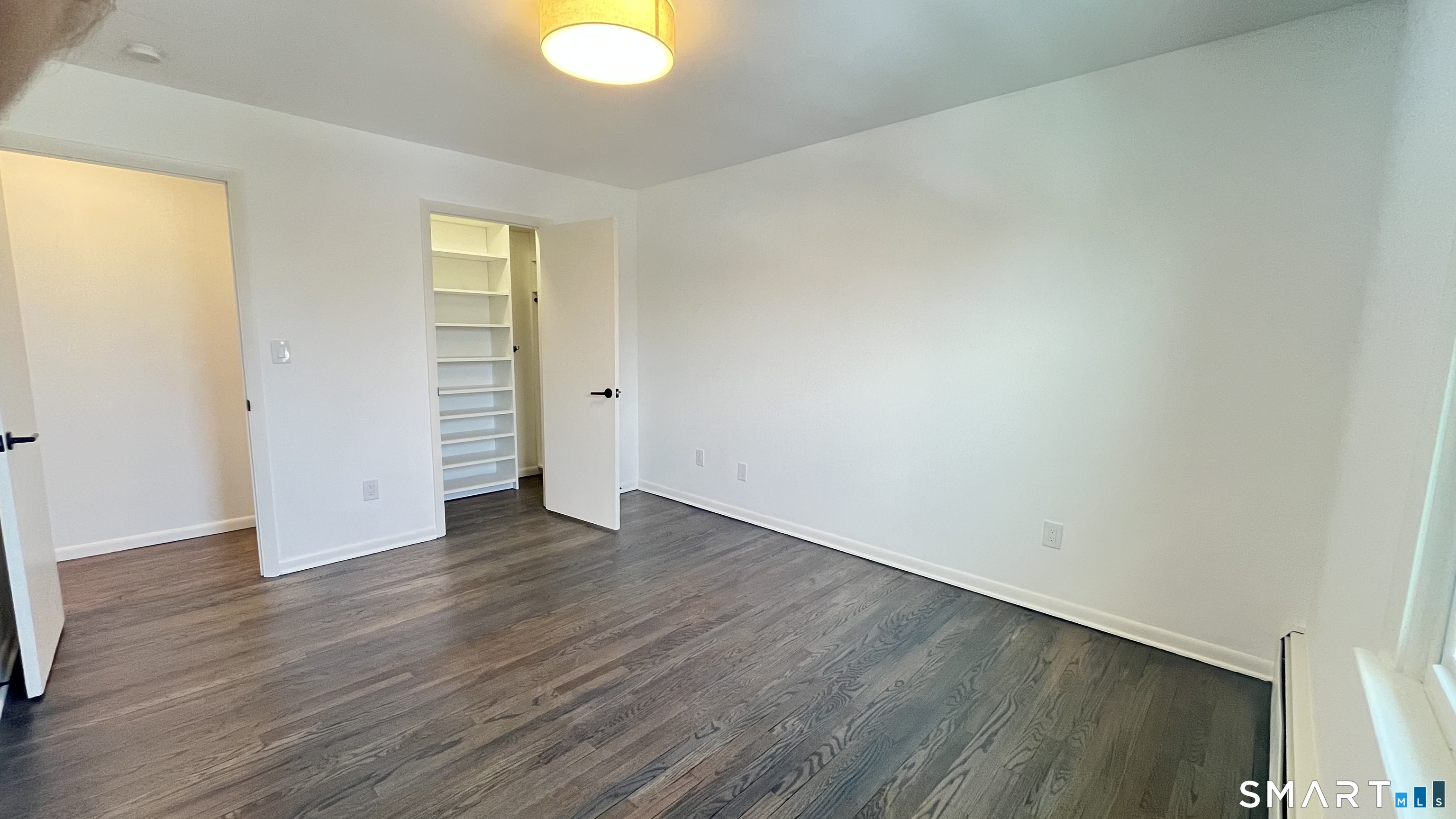 34 Keith Street, Unit 2 Stamford, CT 06902 - Photo 10 of 15 an empty room with wooden floor and windows