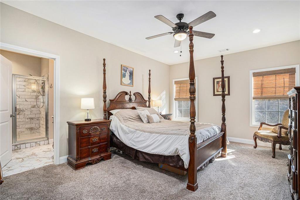 85 Jane Harris Road Dallas, GA 30157 - Photo 14 of 33 a bedroom with a bed and a chandelier