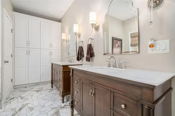 a bathroom with a sink vanity and mirror