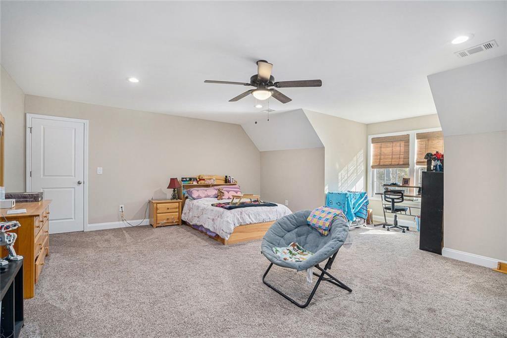 85 Jane Harris Road Dallas, GA 30157 - Photo 19 of 33 a bedroom with furniture and a chandelier