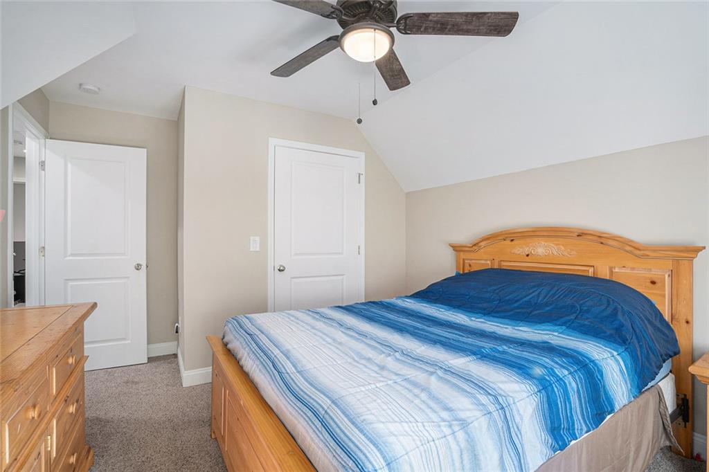 85 Jane Harris Road Dallas, GA 30157 - Photo 22 of 33 a bedroom with a bed and a chandelier