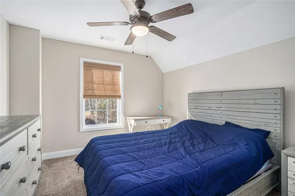 a bed sitting in a bedroom next to a window