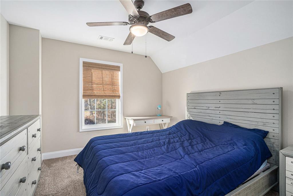 85 Jane Harris Road Dallas, GA 30157 - Photo 23 of 33 a bed sitting in a bedroom next to a window
