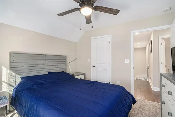 a bedroom with a bed and a ceiling fan